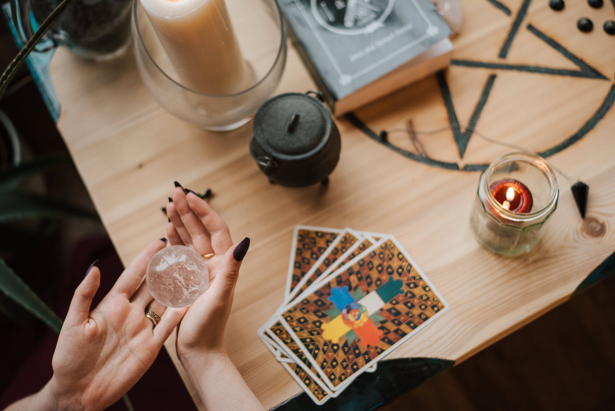 Crop soothsayer predicting fate with magic ball at home tarot cards