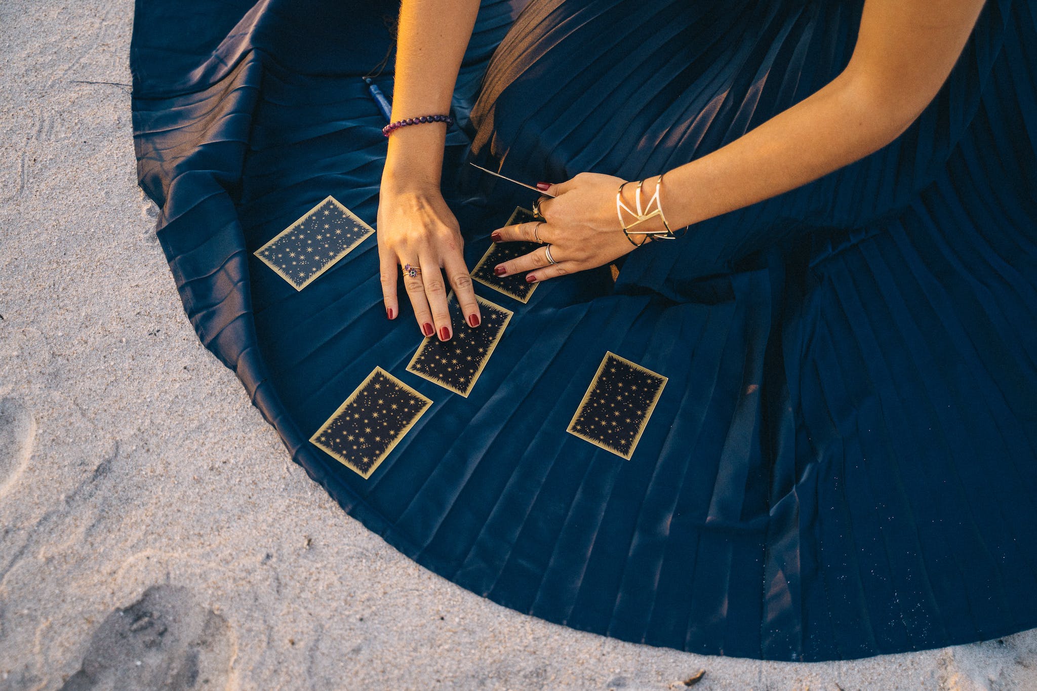 Woman In Blue Skirt Holding Tarot Cards questions for tarot reading
