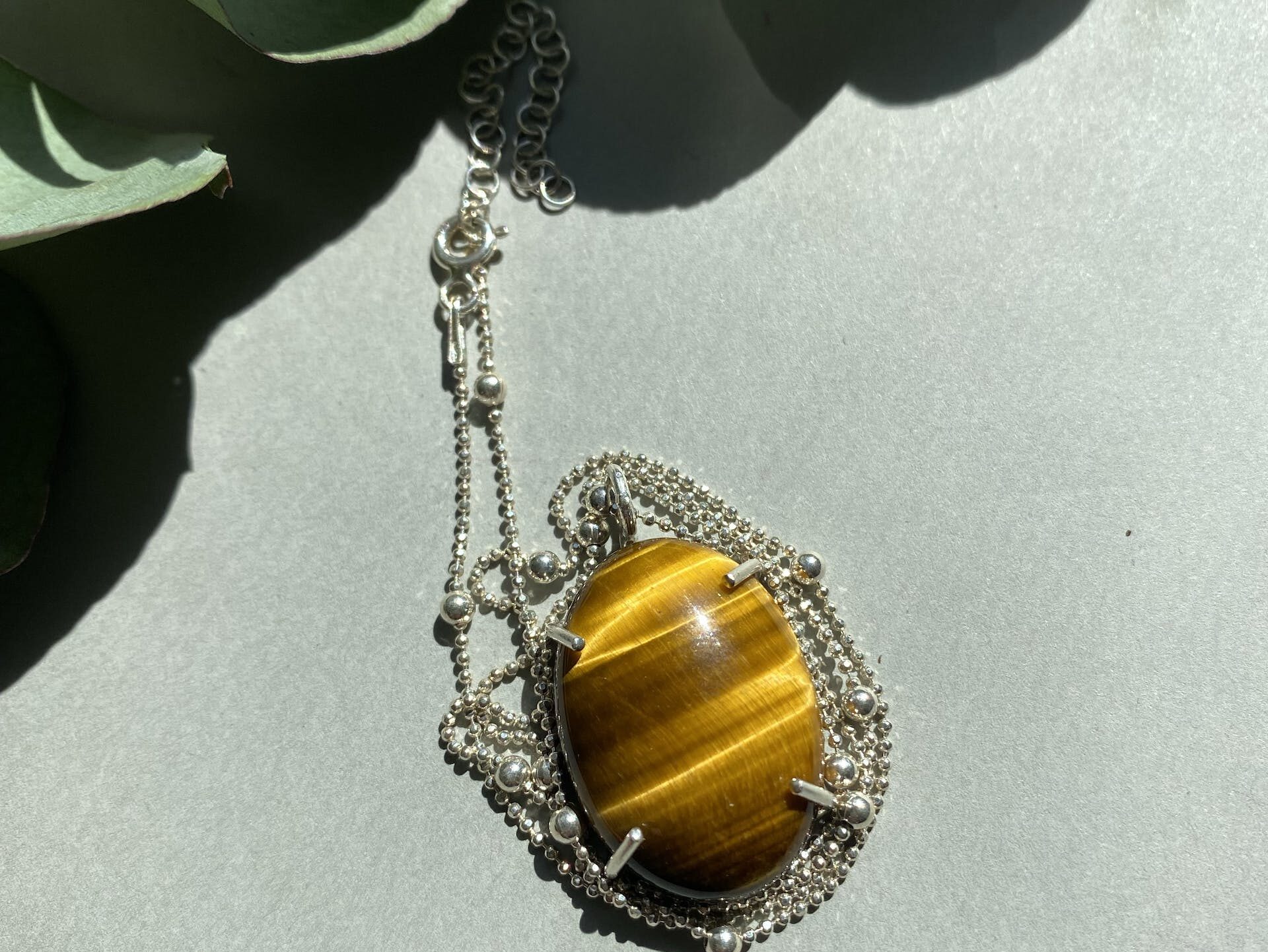 A tiger eye pendant on a chain