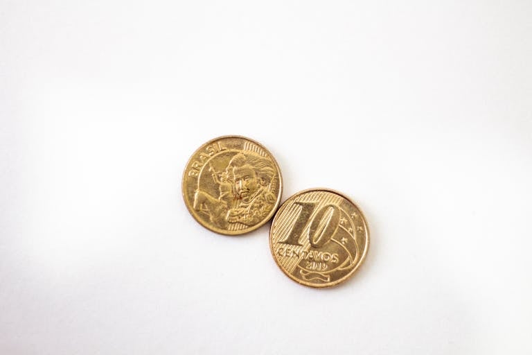 High-quality image of two Brazilian 10 centavos coins on a white surface.